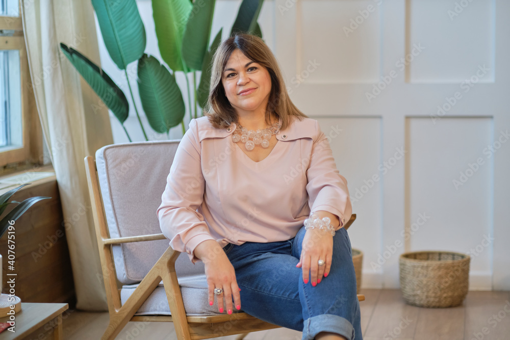 Portrait portrait of a confident mature woman. smiling woman looking at camera with big grin. Successful middle aged woman at home smiling. Portrait portrait of a confident mature woman. smiling woman looking at camera with big grin. Successful middle aged woman at home smiling.