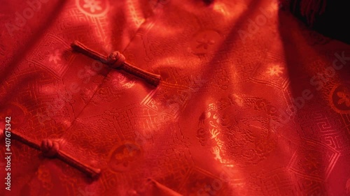 mandarin oranges and chinese red envelope with males cheongsam on wood background