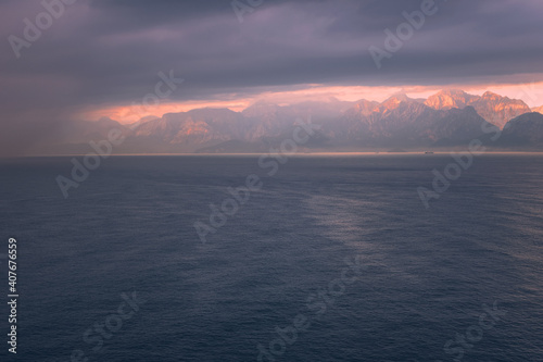 Beautiful pinky sunrise over the sea and mountains in Antalya, Turkey © Khrystsina
