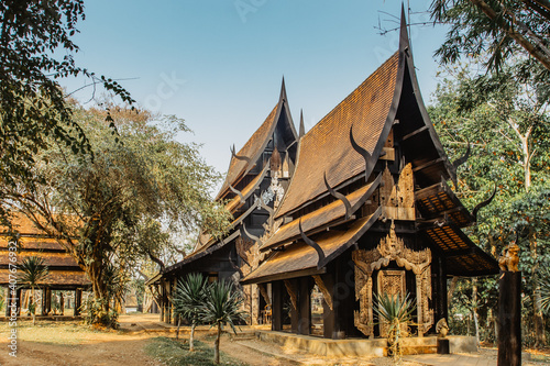 Black Temple, Baan Dam, in Chiang Rai,Thailand, provides collection of skins, bones, teeth of animals.Popular tourist place.Wooden house gold facade.Carved painted wood.Thai style house decor. © Eva