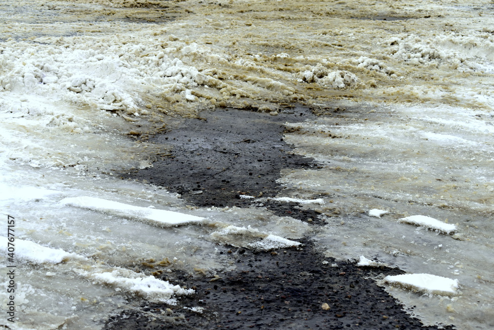 the asphalt appeared from under the snow on the road