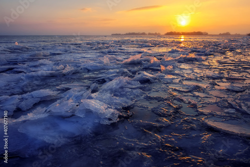 Sunrise and frozen sea. Beautiful winter landscape with lake in morning time.