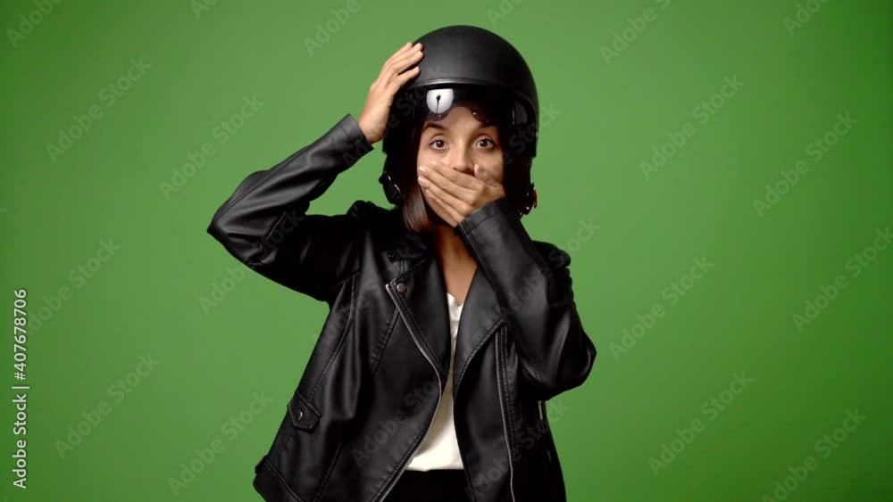 Womanm holding a motorcycle helmet intending to realizes the solution while lifting a finger up
