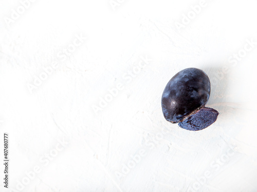 Ugly funny accrete plums on a light background. Flat lay. Copy space. photo