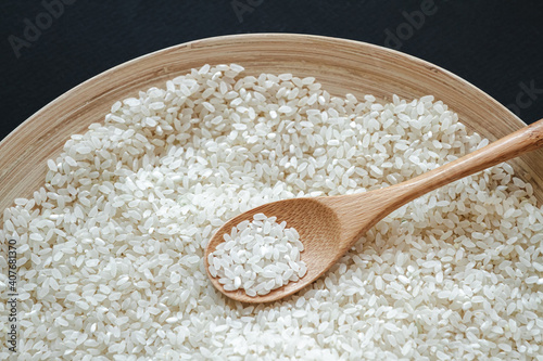 White round rice in wooden or bamboo spoon