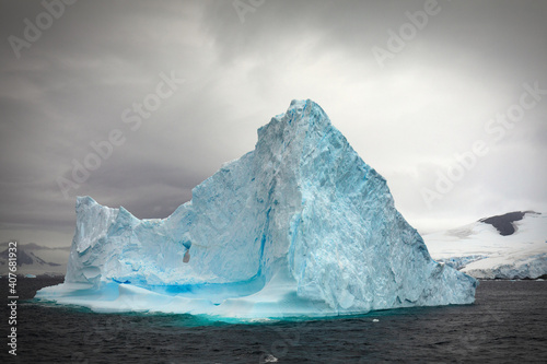 Impressive iceberg with a special sky in the Gerlache Strait in Antarctica.