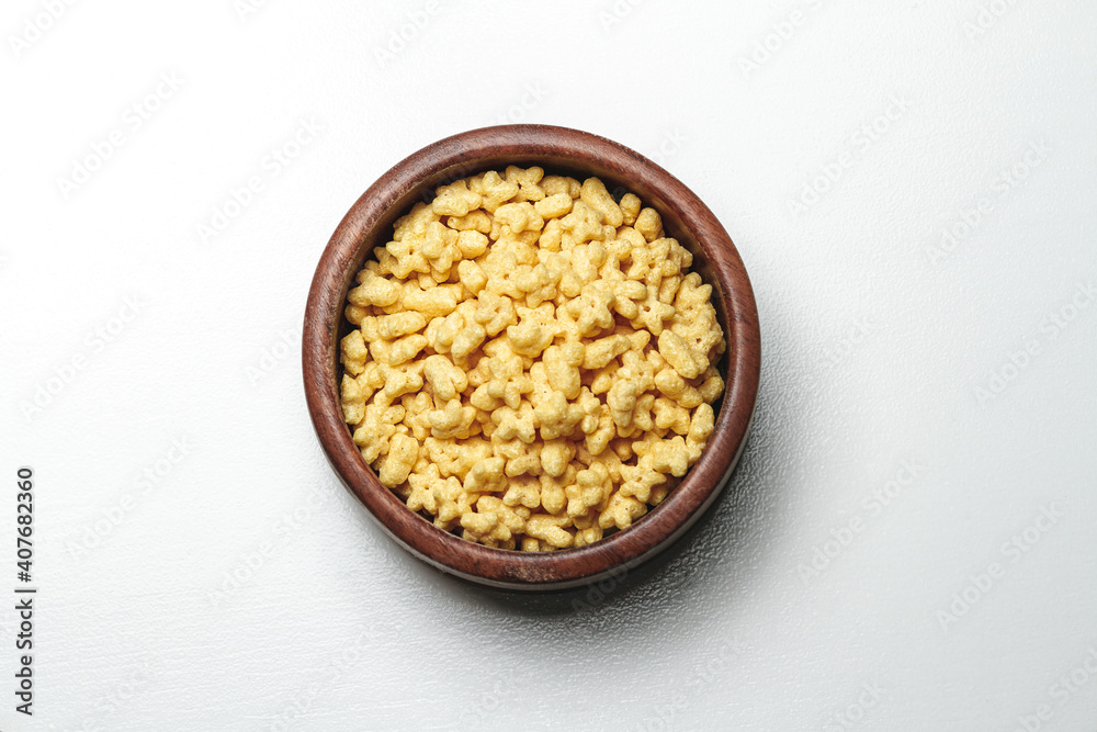 Wooden bowl with quick breakfast cereal on white background Wooden bowl with quick breakfast cereal on white background