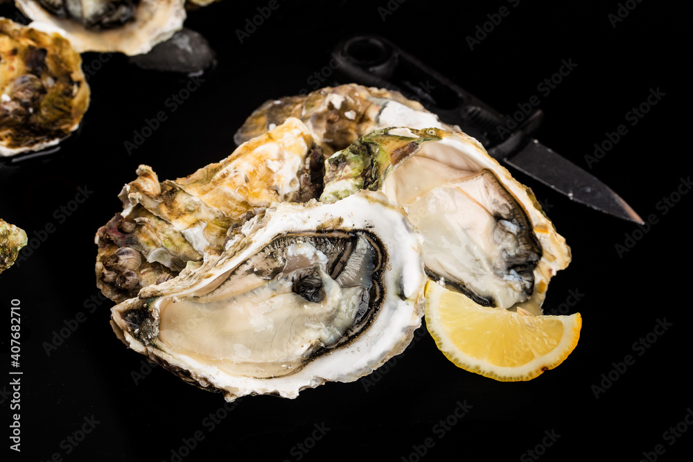 opened oysters ice lemon black surface (2) opened oysters ice lemon black surface (2)