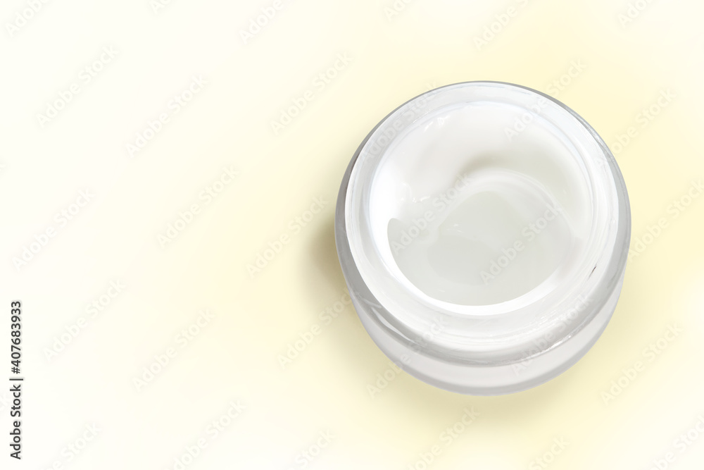 Jar of organic skin care cream isolated on a pale yellow background with clipping path. Copy space Jar of organic skin care cream isolated on a pale yellow background with clipping path. Copy space