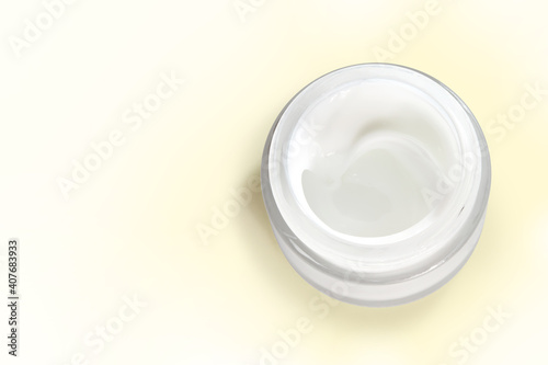 Jar of organic skin care cream isolated on a pale yellow background with clipping path. Copy space