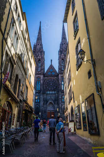 View, from the rue des Gras, on the facade of the gothic cathedral of Clermont-Ferrand, in Auvergne, France  photo