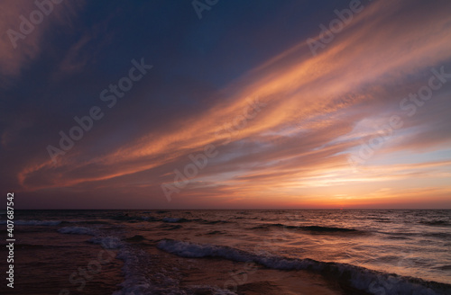 Sunset over the sea shore, sandy beach, colorful sky © Алексей Голубев