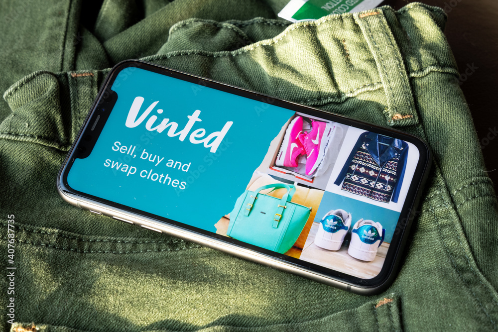 Iphone with vinted logo on screen on vintage denim fabric. Vinted is a  Lithuanian online marketplace and community for second hand clothes and  accessories. Stock Photo | Adobe Stock