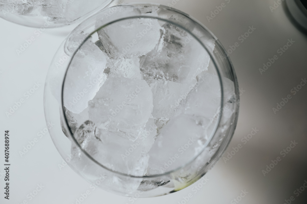 Ice in a glass of wine prepared for a special cocktail for a bartender's bar or restaurant. Ice in a glass of wine prepared for a special cocktail for a bartender's bar or restaurant.