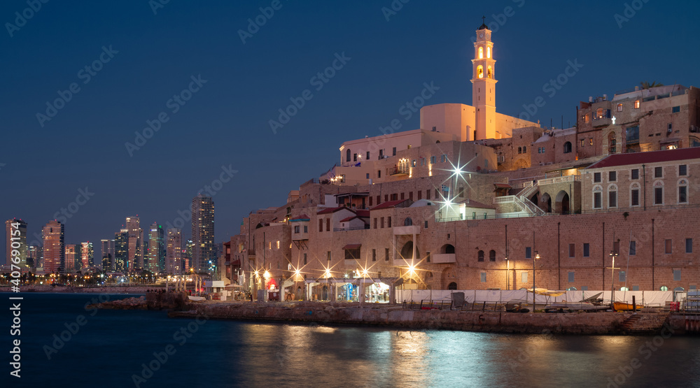 Night Jaffa and Tel Aviv skyline. Ancient city on mediterranean sea