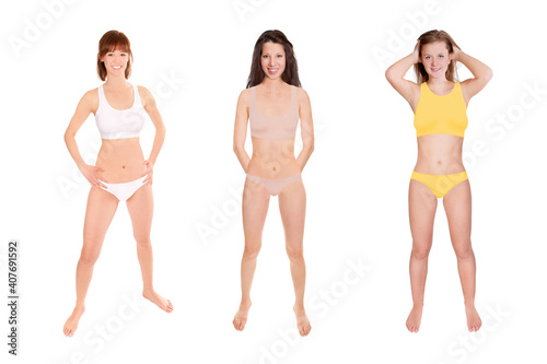 Full length portraits of three young laughing women wearing different bikinis, isolated in front of white studio background