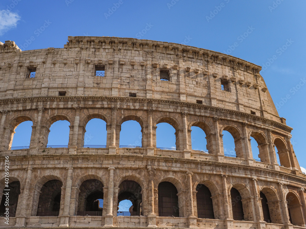 Detail of Colosseum or gladiator Arena famous stony ancient architecture. Arches of Flavian Amphitheatre. Construction of antique Roman Empire. Arena Flavio or Coliseum, iconic symbol of Imperial Rome