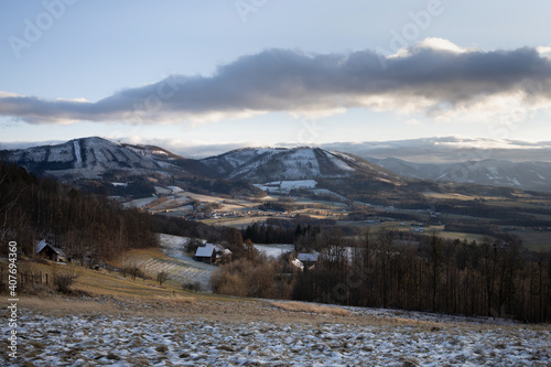 View from Kozlovicka hora, Podbeskydi, Czech Republic, Czechia - hills and mountains in the winter and wintertime. Houses and cottages in the nature - authentic rural area and village in countryside. photo