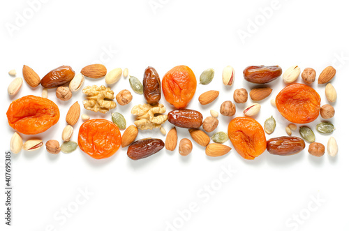 Nuts and dried fruits on a white background. Sources of antioxidants and vitamins. Healthy eating. Flat top view. For a healthy and vegetarian diet. Copy space