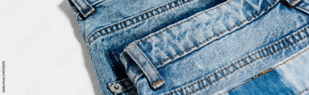 close up view of pair of blue jeans on white background, banner close up view of pair of blue jeans on white background, banner