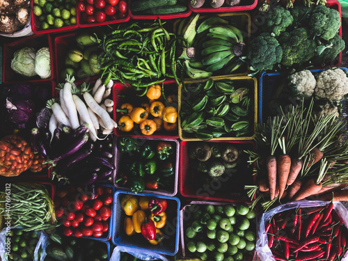 Top view on a large assortment of row loose vegetables and fruits for sale in a street. Short circuit production at Hue Market