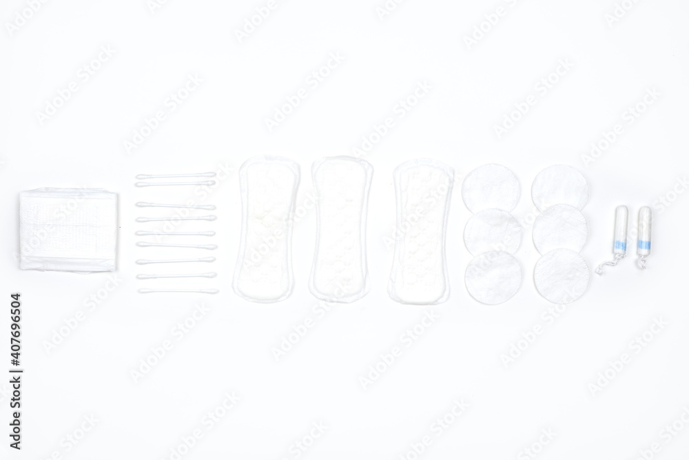 Obraz premium Different female hygienic products on white background. Feminine pads and tampons on white. Sanitary napkins and menstrual womens tampons