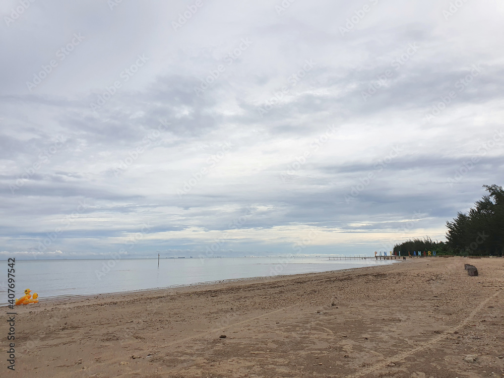 January 2021, Balikpapan Indonesia, lamaru beach, people enjoys calm ocean waves, travel tourism destination