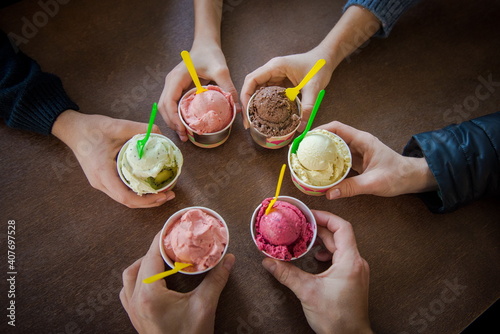 ice cream in hand. Multicolored ice cream with friends