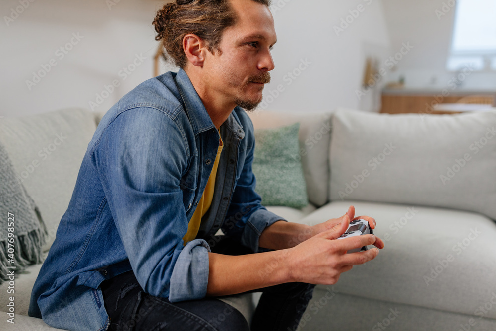 Young male playing video games at home Young male playing video games at home
