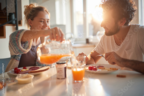 Slika na platnu Happy couple having breakfast together