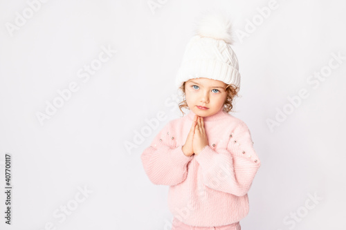 cute baby girl in pink winter clothes on white background, space for text