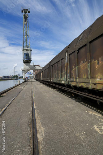 Karlsruhe, Germany: port of Karlsruhe with freight wagons, railway, crane, river rhine ans storage buildings