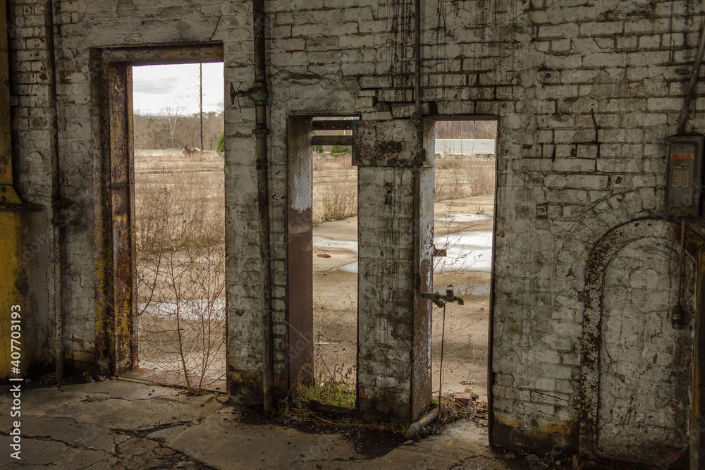 Various doorways in a brick building of an abandoned factory in the deep south