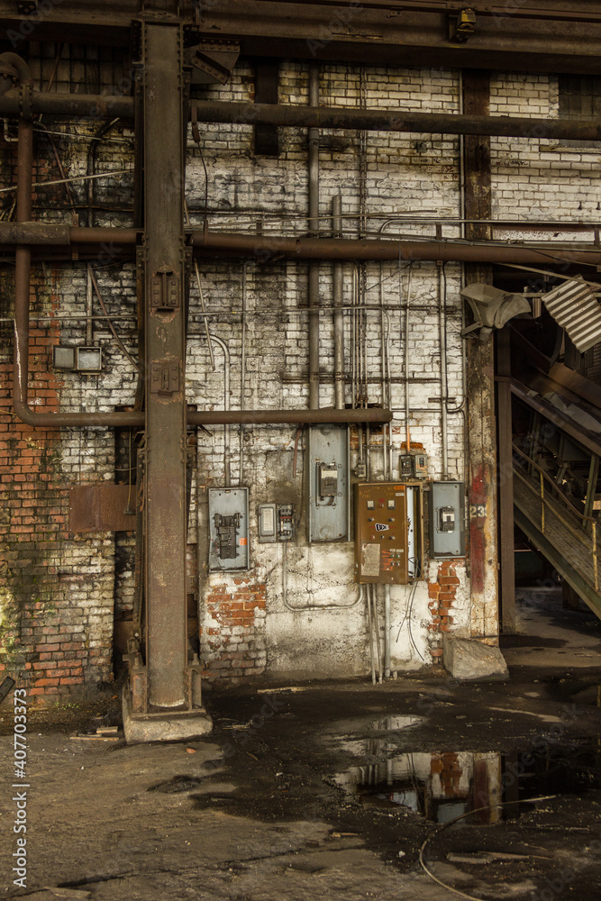 Closeup of brick wall with electrical meters in an abandoned factory in the deep south