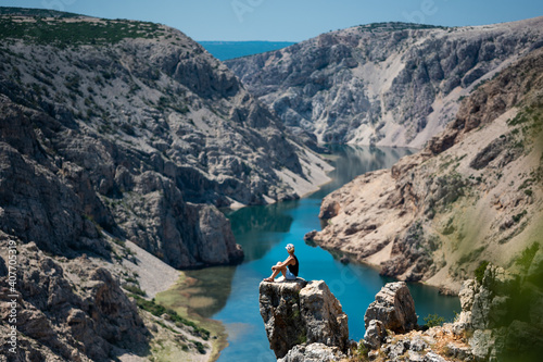 Woman enjoy the view - top of a mountain in Croatia - Landscape with blue river