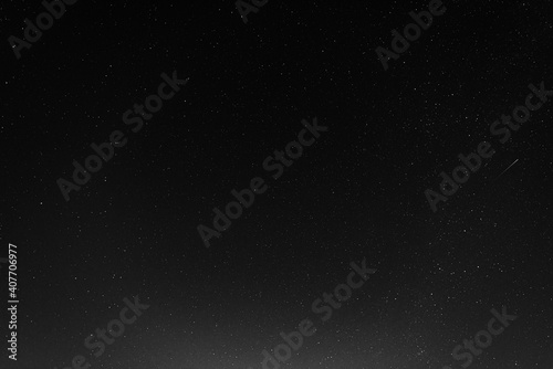 A starry sky with many stars and a flying meteor