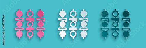 Paper cut Grilled shish kebab on skewer stick icon isolated on blue background. Meat kebab on skewer stick. Picnic with grilled meat. Paper art style. Vector.