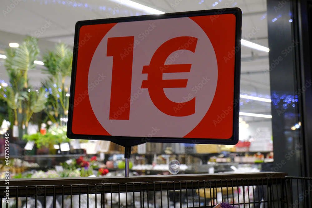 One euro sign on paper board across the store entrance. Retail concept