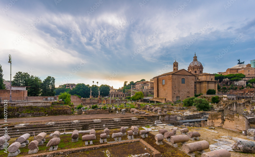 Fototapeta premium Magnificent old buildings in Rome behind ancient remains, Italy