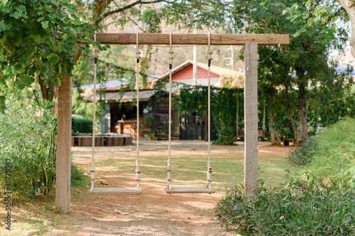 Wooden swing in front of the house