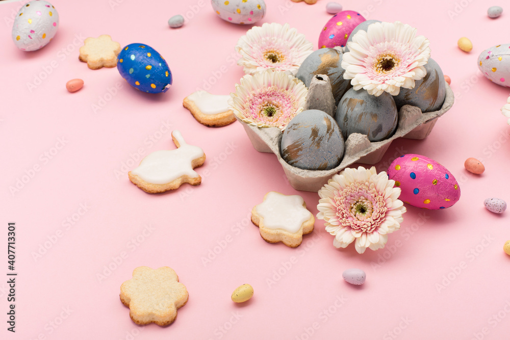 Homemade Easter sugar cookies, chocolate eggs, flowers on pastel pink background. Festive Easter breakfast concept. Homemade Easter sugar cookies, chocolate eggs, flowers on pastel pink background. Festive Easter breakfast concept.