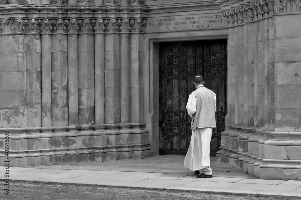 Naklejka premium The monk enters the door of the monastery.