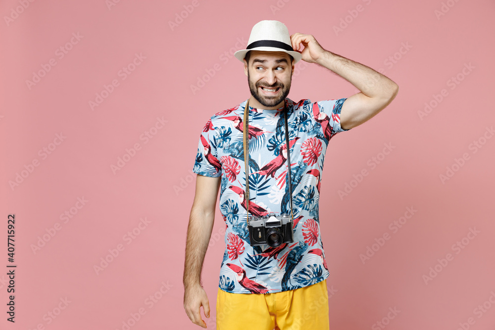 Puzzled confused young traveler tourist man in summer casual clothes hat with photo camera put hand on head isolated on pink background. Passenger traveling on weekends. Air flight journey concept. Puzzled confused young traveler tourist man in summer casual clothes hat with photo camera put hand on head isolated on pink background. Passenger traveling on weekends. Air flight journey concept.