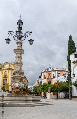 town square and historic fountain and buildings in the historic old city of Seville