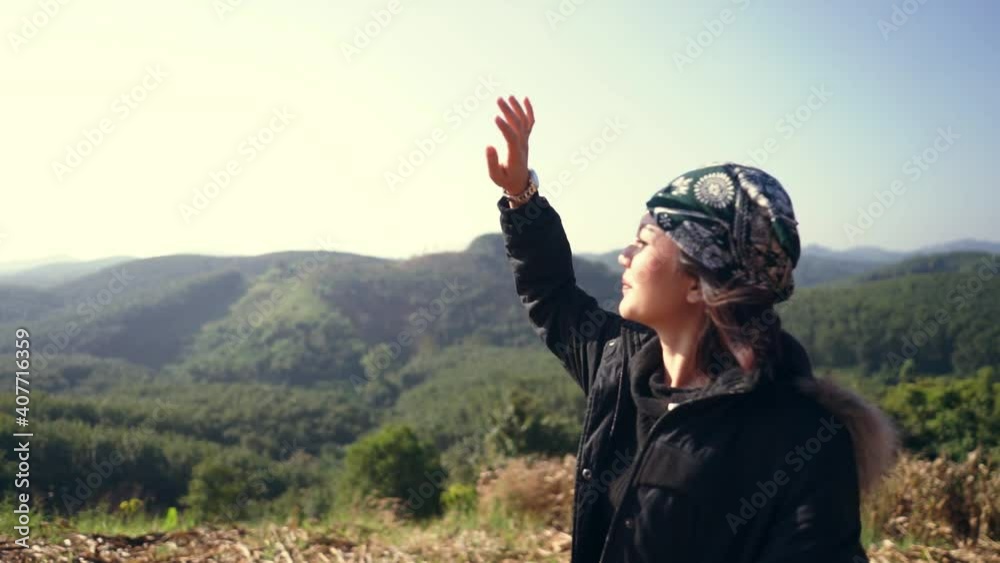 Hipster Asian woman traveller looking view on peak mountain on the morning. Hiker woman in coat on the mountains.