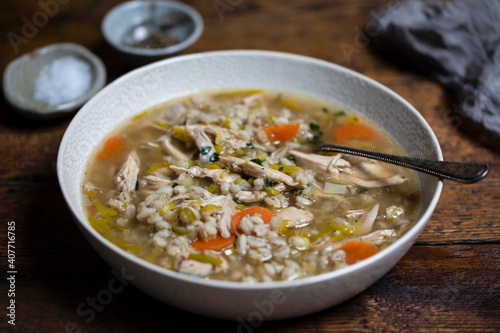 Canvas-taulu Comforting winter soup with chicken, pearl barley and vegetables
