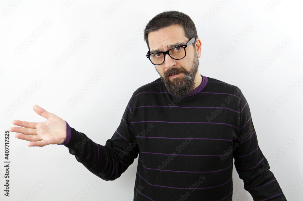 Bearded man with glasses on isolated white background clueless and confused with open arms, no idea and doubtful face Bearded man with glasses on isolated white background clueless and confused with open arms, no idea and doubtful face