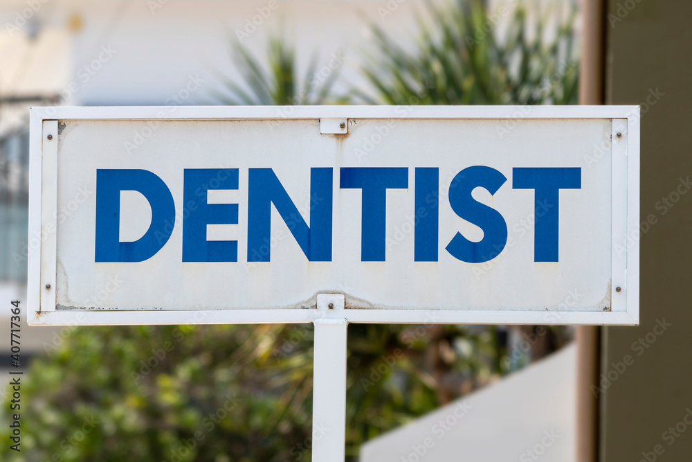 Fototapeta premium Dentist sign outside practitioner in bold blue and white
