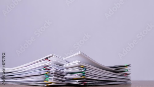 4K-Stop motion Stack overload document report paper with colorful paperclip on white background, business concept footage paperless used.