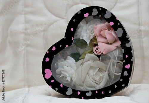 White  and pink artificial textile roses in a heart shaped Valentines day box	
 photo